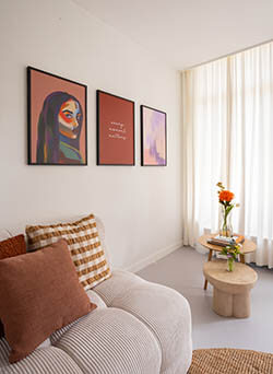 Three frames above the sofa